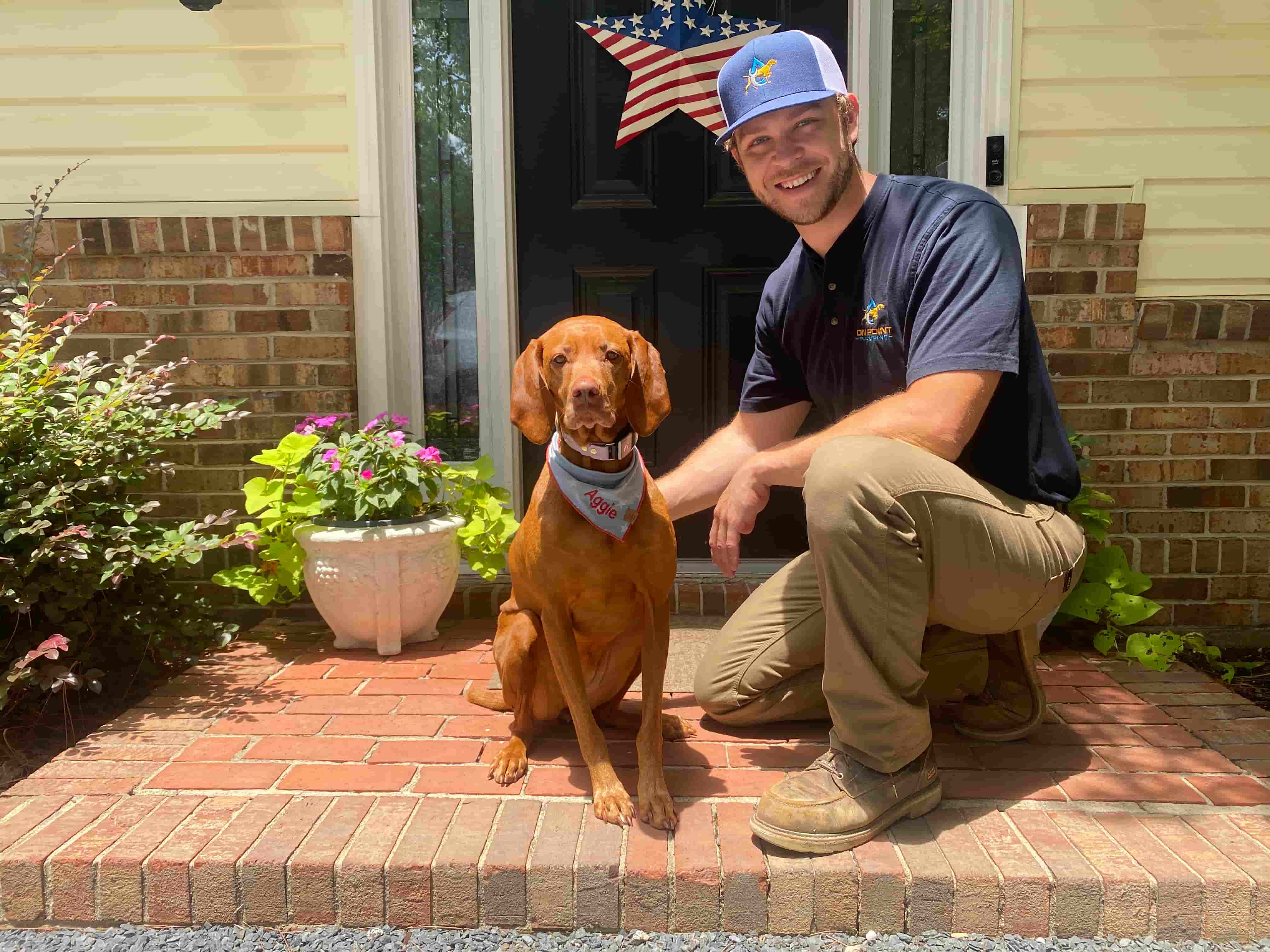 Phillip Williams, owner of On Point Plumbing and Filtration, with his pointer Aggie